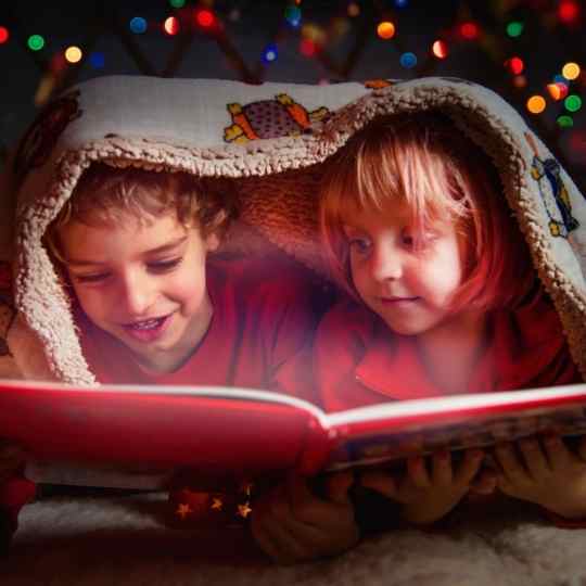 A boy and girl experiencing the magic of books.